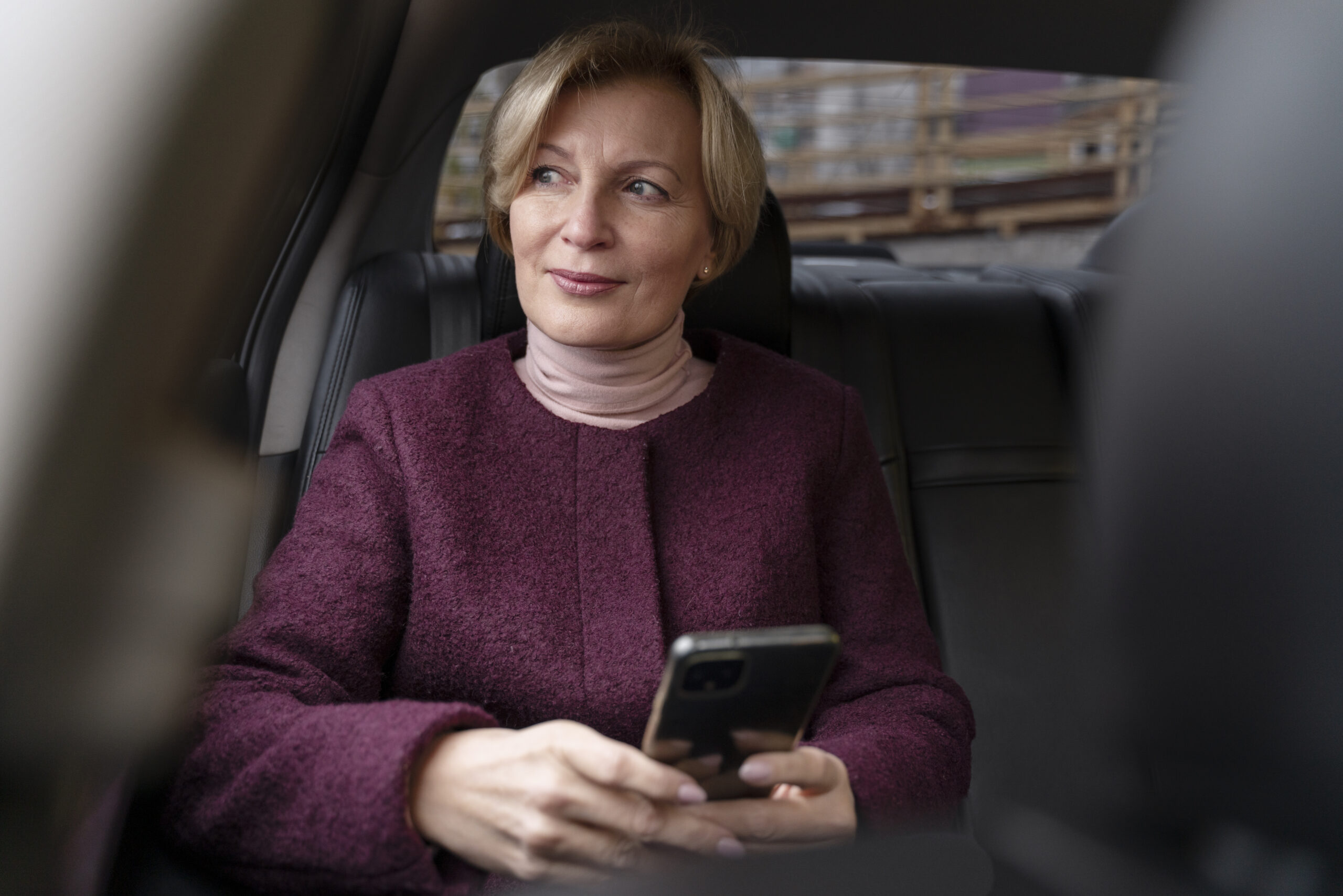businesswoman sitting in a chauffeured car
